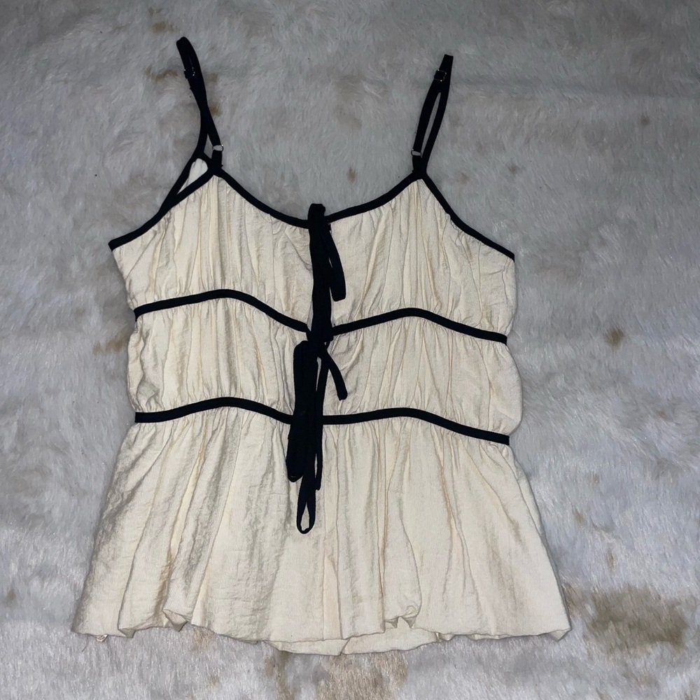 Elegant Cream Sleeveless Top with Black Tie Front